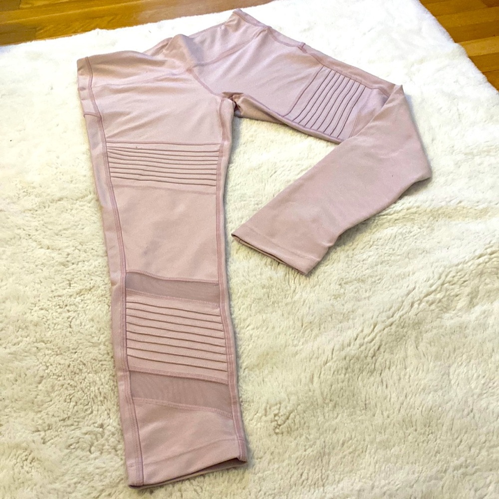 Medium, light pink, high rise legging with moto and mesh detail on legs.
